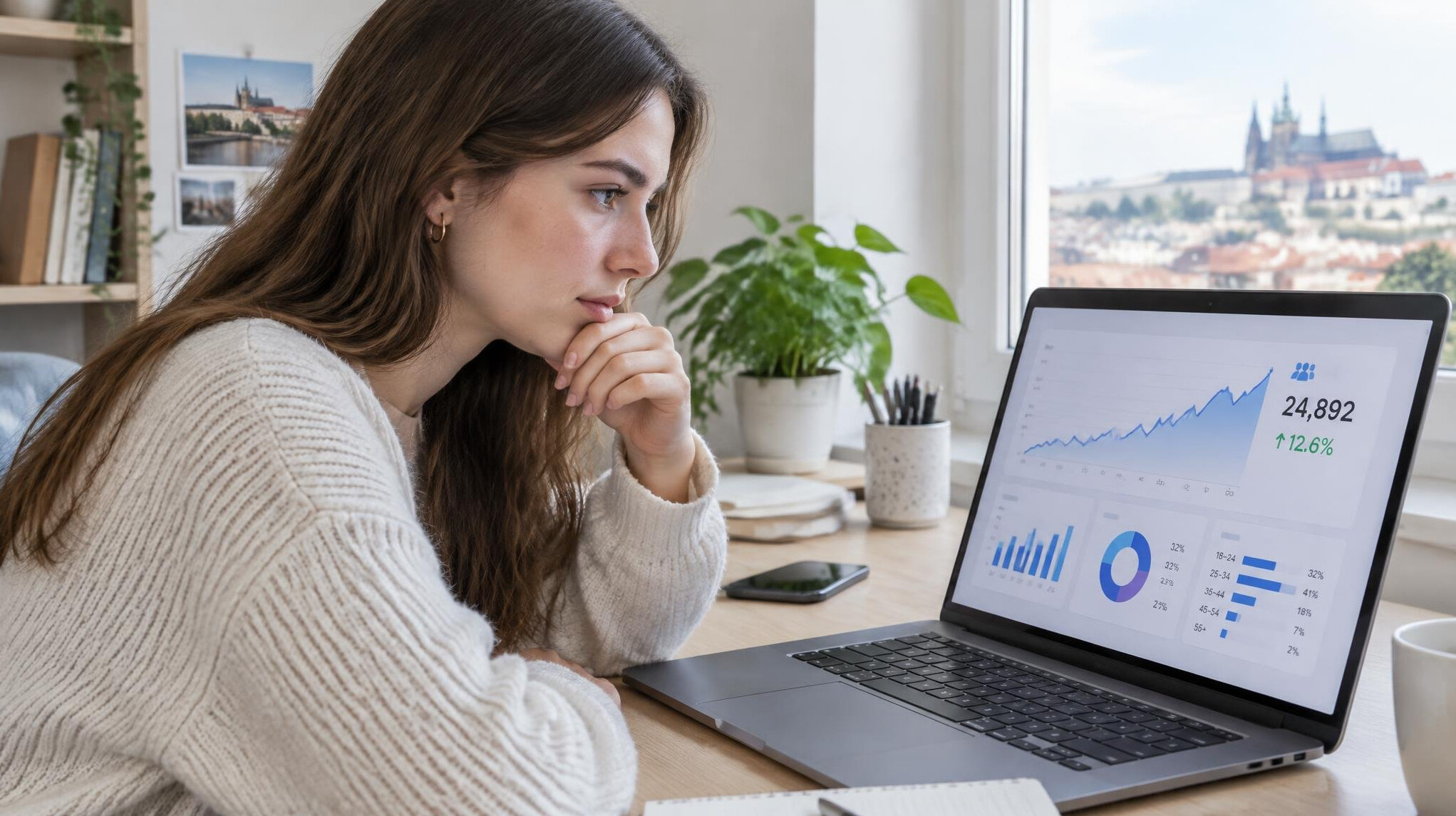 Woman reviewing audience growth analytics charts on a laptop screen